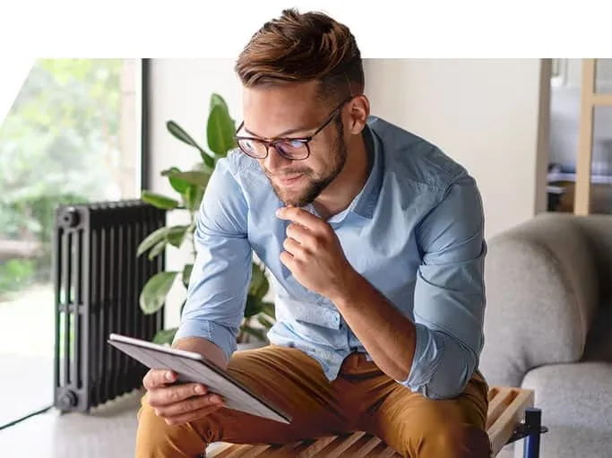 A trader reading the markets on a tablet at home