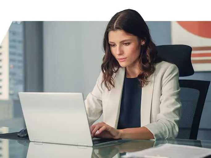 A trader working at her laptop